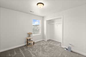 Unfurnished bedroom with a closet and light carpet