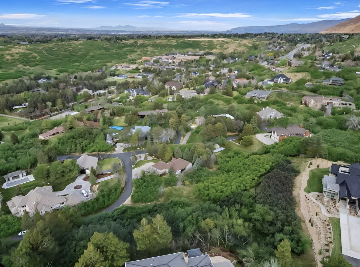 Aerial view of residential area featuring a mountainous background