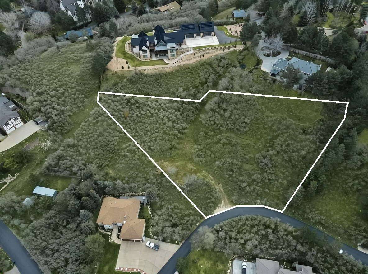 Aerial perspective of suburban area featuring property parcel outlined