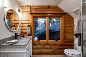 Bathroom with log walls and vanity
