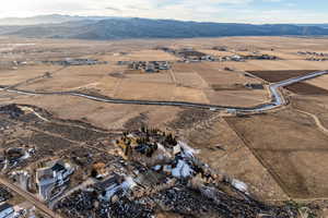Aerial view of property's location with rural landscape and mountains