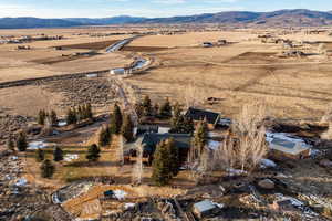 Aerial view of property's location featuring a mountain backdrop and rural landscape