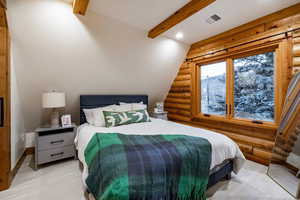 Bedroom with log walls, recessed lighting, lofted ceiling with beams, and a mountain view