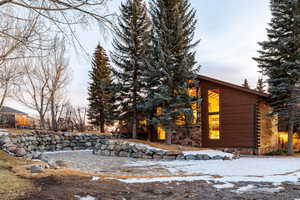 View of snowy exterior with log siding