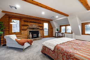 Carpeted bedroom featuring recessed lighting, access to exterior, rustic walls, and lofted ceiling with beams