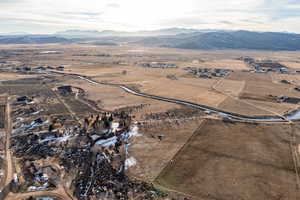 Aerial overview of property's location with rural landscape and a mountainous background