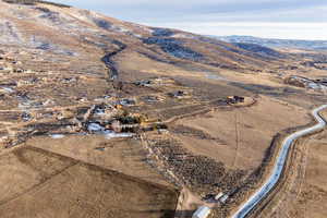 Aerial view of property's location with rural landscape and a mountainous background