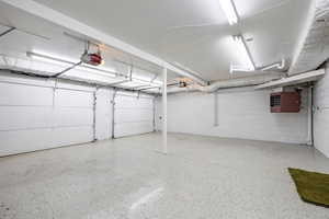 Garage featuring a heating unit and a garage door opener