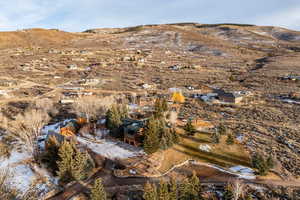 Aerial view of property and surrounding area featuring mountains and rural landscape