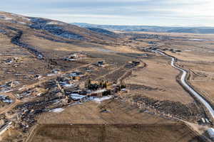 Aerial overview of property's location with rural landscape and a mountain backdrop
