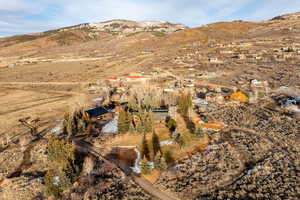 Aerial overview of property's location featuring a mountainous background and rural landscape