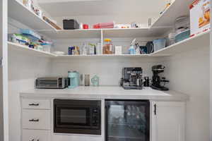 Storage area featuring wine cooler