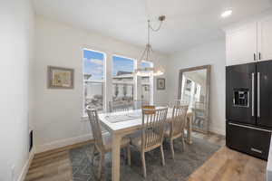 Dining space with light wood-style flooring, plenty of natural light, and recessed lighting