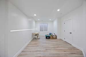 Misc room with light wood finished floors, recessed lighting, and an office area