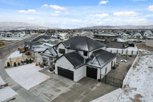 Snowy aerial view with a residential view and a mountain view