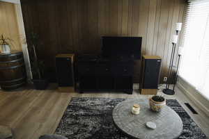 Living area with wood walls and light LVP flooring.