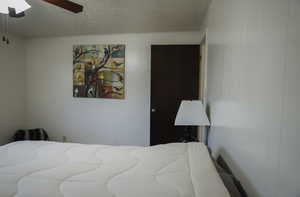 Bedroom featuring a textured ceiling and ceiling fan