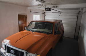 Garage featuring a garage door opener