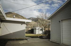 View of patio / terrace with a mountain view and two-car garage.