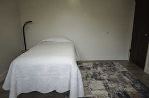 Bedroom with LVP flooring and baseboards