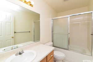 Bathroom with vanity and enclosed tub / shower combo