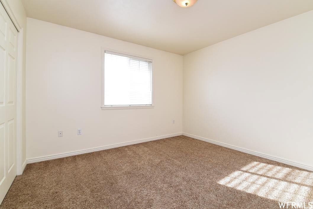 Unfurnished bedroom with a closet and carpet floors