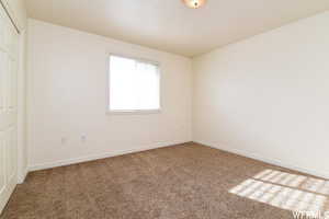 Unfurnished bedroom with a closet and carpet floors