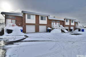 Split foyer home featuring brick siding and an attached garage