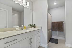 Full bathroom with vanity and a shower with curtain