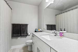 Bathroom featuring vanity and curtained shower