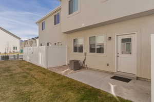 Rear view of house with stucco siding and a patio area