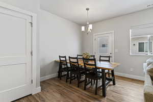 Dining room featuring wood finished floors and suspended lighting