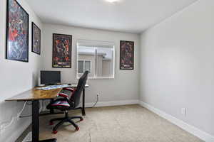 Office space featuring light carpet and baseboards