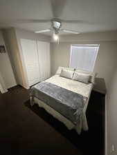 Bedroom featuring a closet, a ceiling fan, and dark colored carpet (4th bedroom)