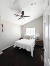 Bedroom featuring dark carpet, ceiling fan, and vaulted ceiling (2nd Bedroom)