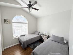 Bedroom featuring lofted ceiling, dark wood-style floors, and ceiling fan (3rd Bedroom)