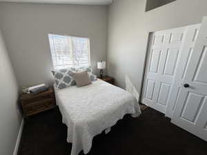 Bedroom featuring baseboards and dark colored carpet (2nd Bedroom)