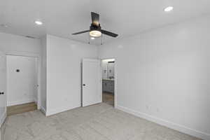 Unfurnished bedroom with light colored carpet, ceiling fan, connected bathroom, and recessed lighting