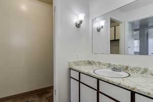 Bathroom with vanity and baseboards