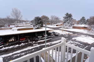 View of snow covered back of property