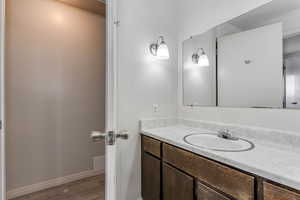 Bathroom featuring vanity and light wood-type flooring