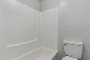 Full bathroom featuring toilet and tub / shower combination