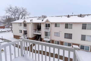 View of snow covered back of property