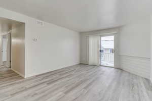 Unfurnished room featuring light wood-style flooring