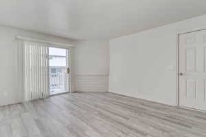 Empty room with light wood-type flooring and baseboards