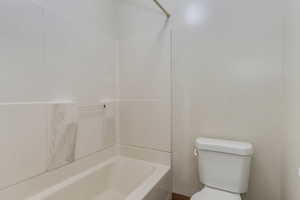 Bathroom with toilet and shower / bath combination