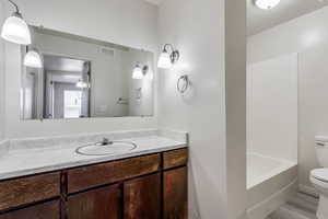 Full bathroom with vanity, bathtub / shower combination, and wood finished floors