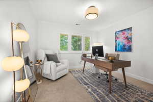 Carpeted office space featuring ornamental molding and baseboards