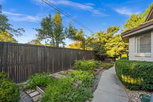 Fenced backyard with a vegetable garden