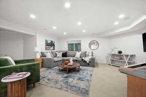Living room featuring light carpet, ornamental molding, and recessed lighting